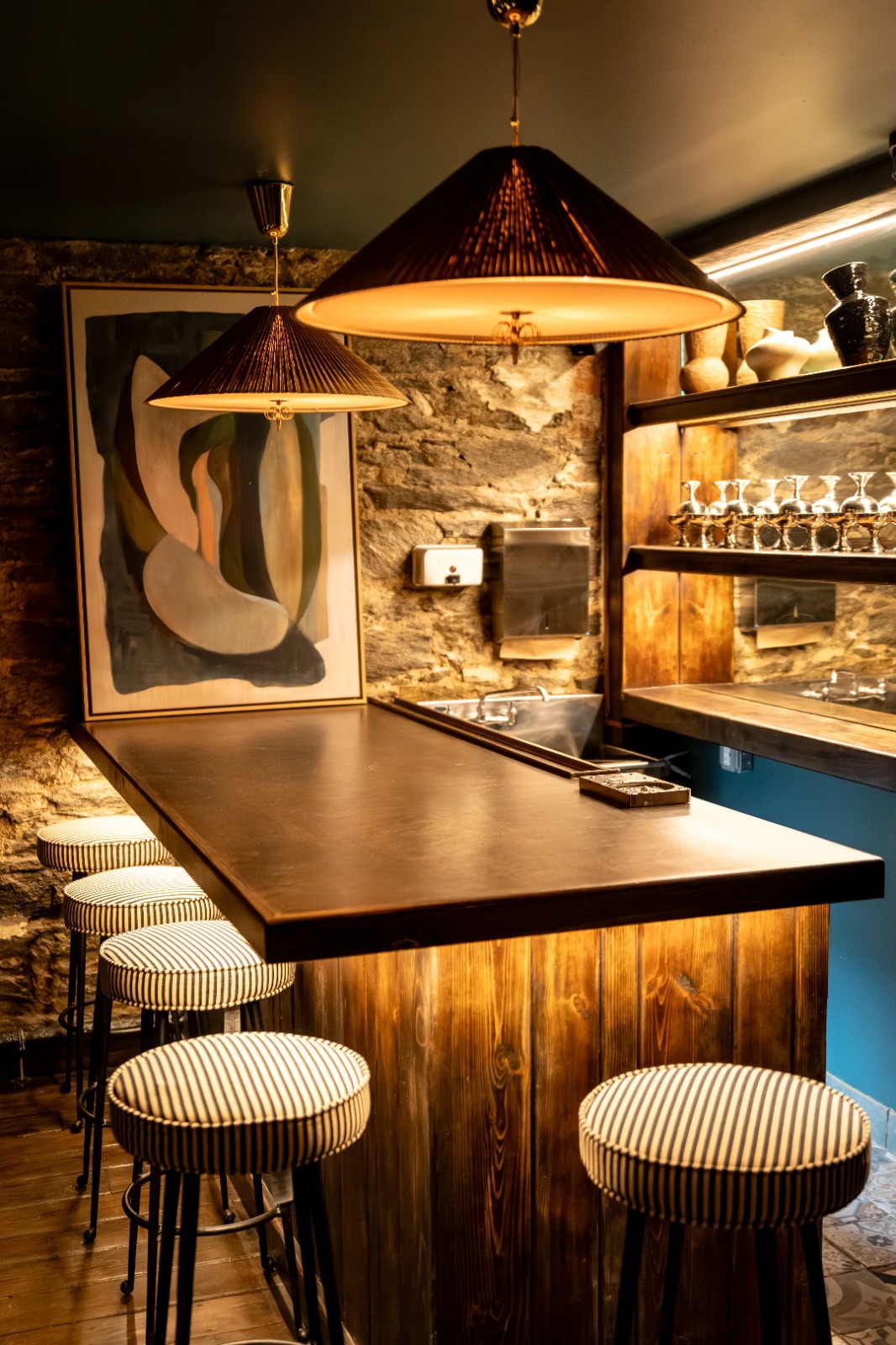 Private bar area with pendant lamps and stools